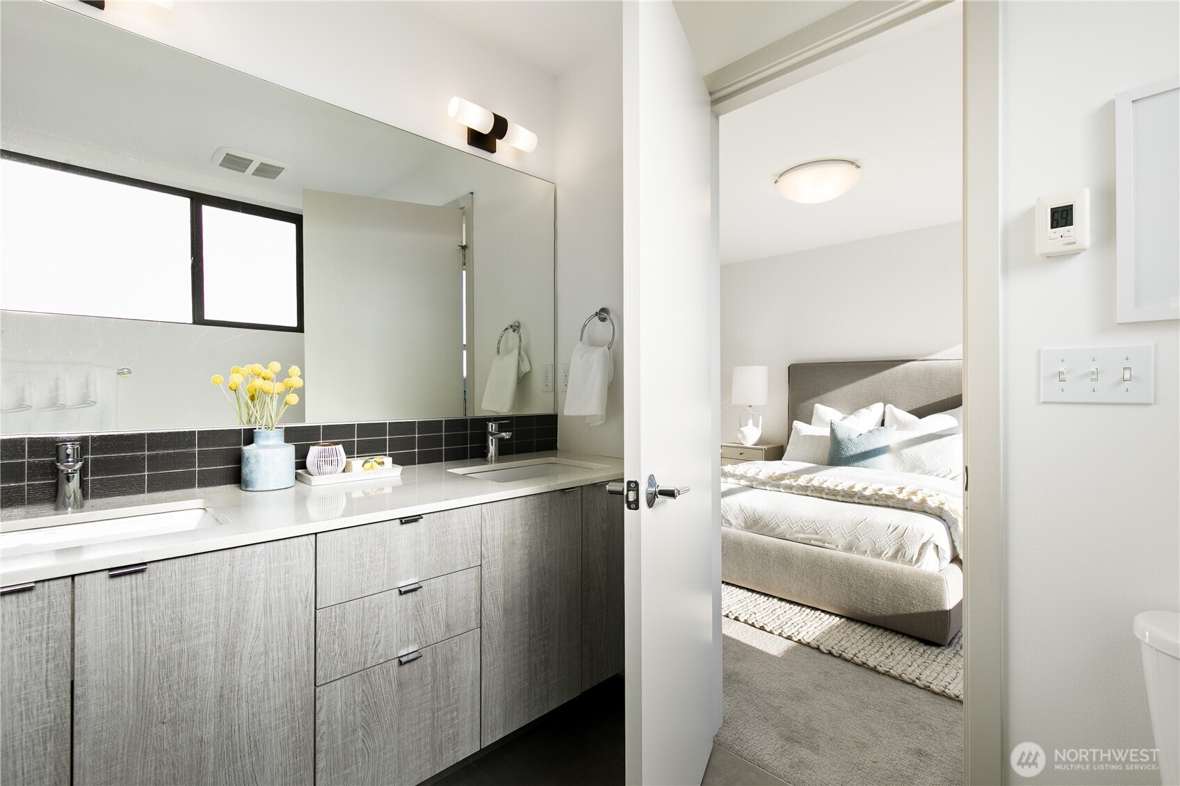 6729 14th Avenue Northwest, Unit B Seattle, WA 98117 - Photo 16 of 36 a en suite bathroom with a double vanity sink and a mirror