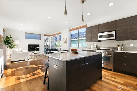 a kitchen with a sink stove and cabinets