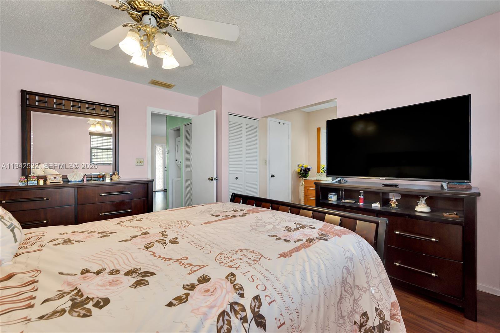 12960 Southwest 66th Lane, Unit 1081 Miami, FL 33183 - Photo 12 of 20 a bedroom with a bed and a flat screen tv