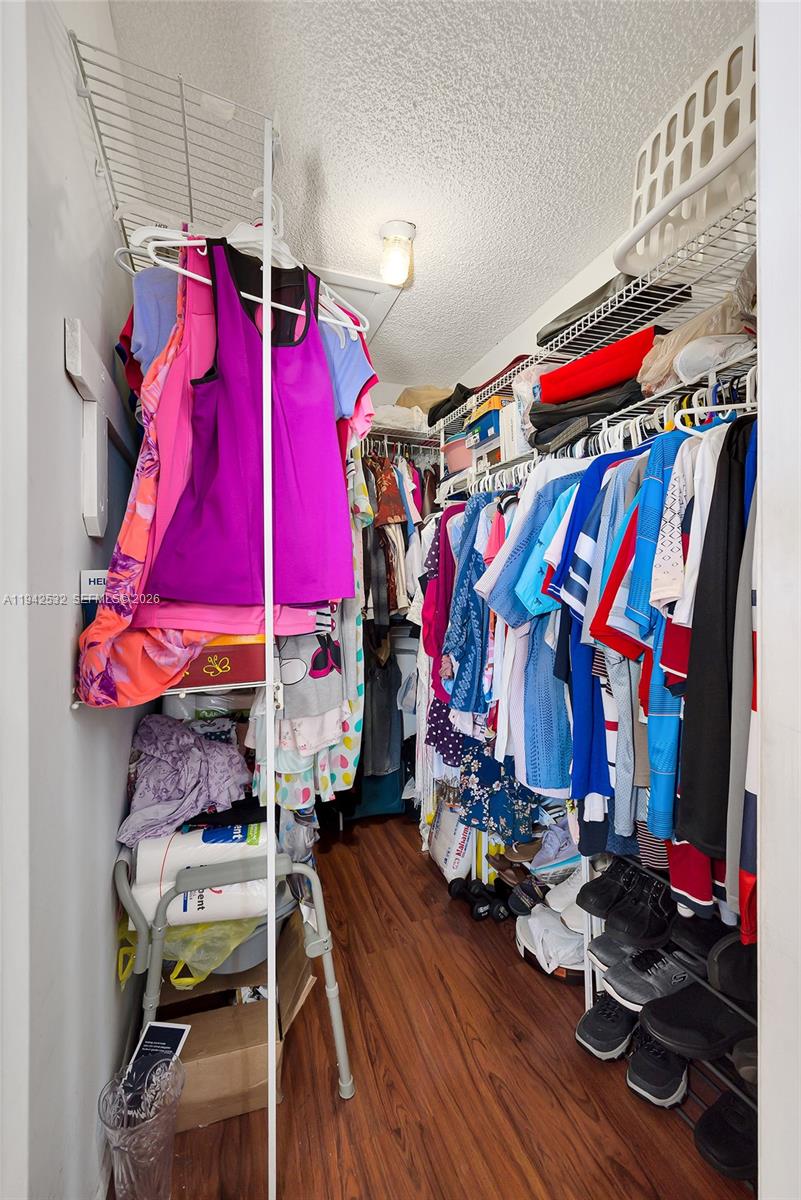 12960 Southwest 66th Lane, Unit 1081 Miami, FL 33183 - Photo 13 of 20 a view of walk in closet with clothes
