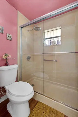 a bathroom with a toilet and shower