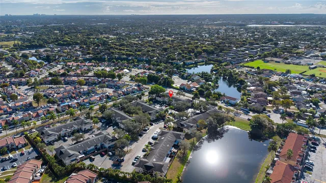 an aerial view of residential houses with outdoor space and swimming pool