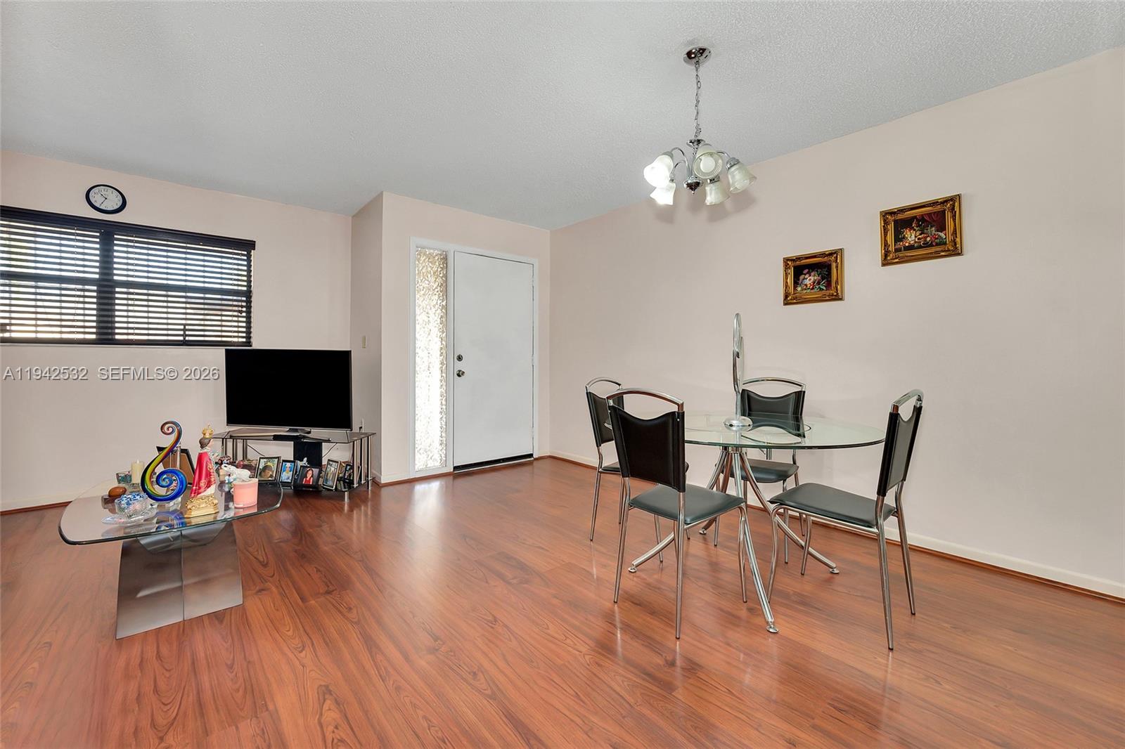 12960 Southwest 66th Lane, Unit 1081 Miami, FL 33183 - Photo 4 of 20 a living room with furniture and wooden floor