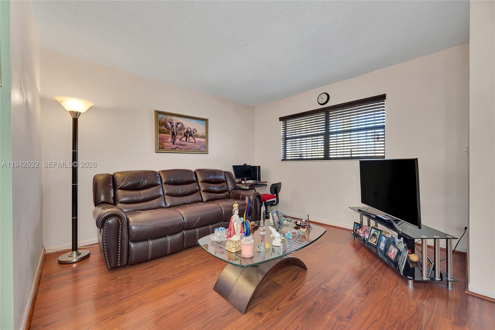 12960 Southwest 66th Lane, Unit 1081 Miami, FL 33183 - Photo 5 of 20 a living room with furniture and a flat screen tv