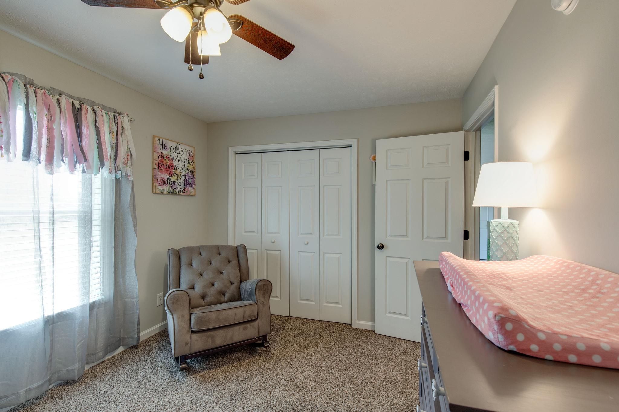 349 Lear Road Portland, TN 37148 - Photo 16 of 24 a bedroom with a bed and a chandelier