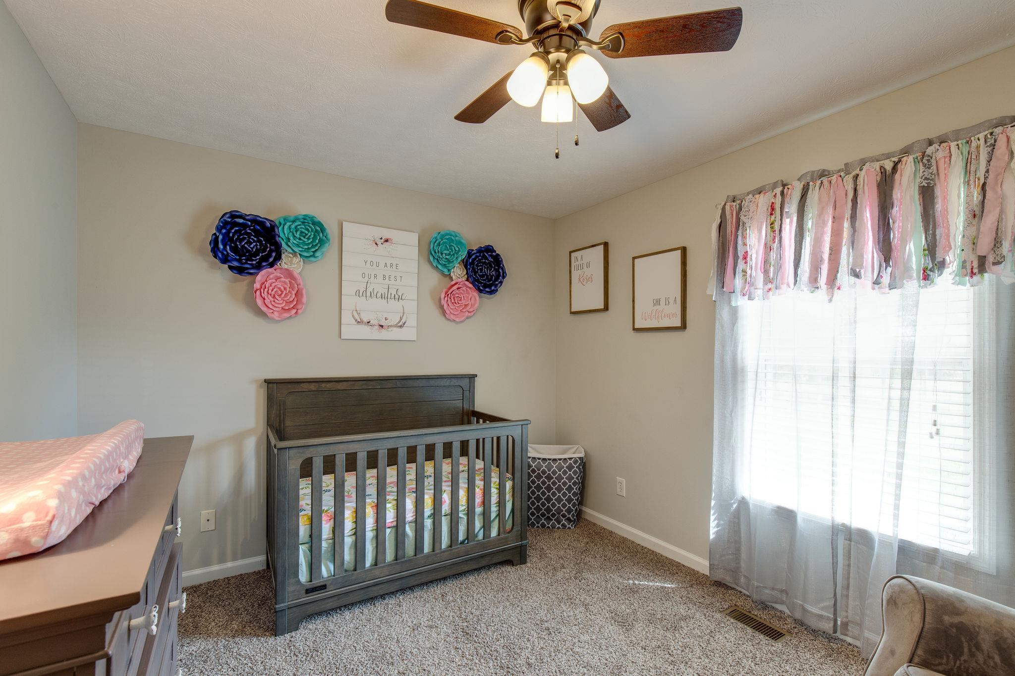 349 Lear Road Portland, TN 37148 - Photo 17 of 24 a bedroom with a bed and a chandelier