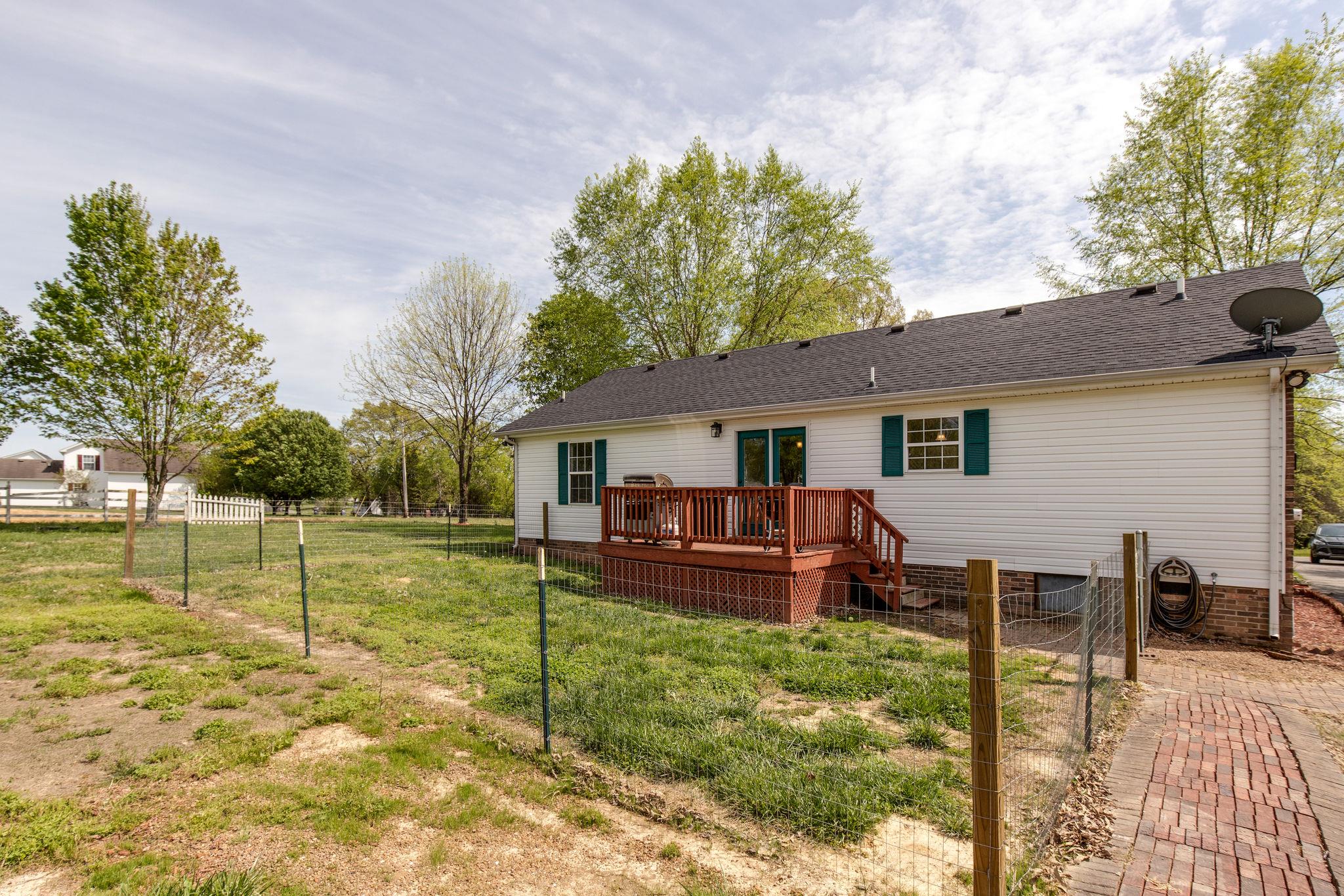 349 Lear Road Portland, TN 37148 - Photo 20 of 24 a view of a house with backyard and a tree