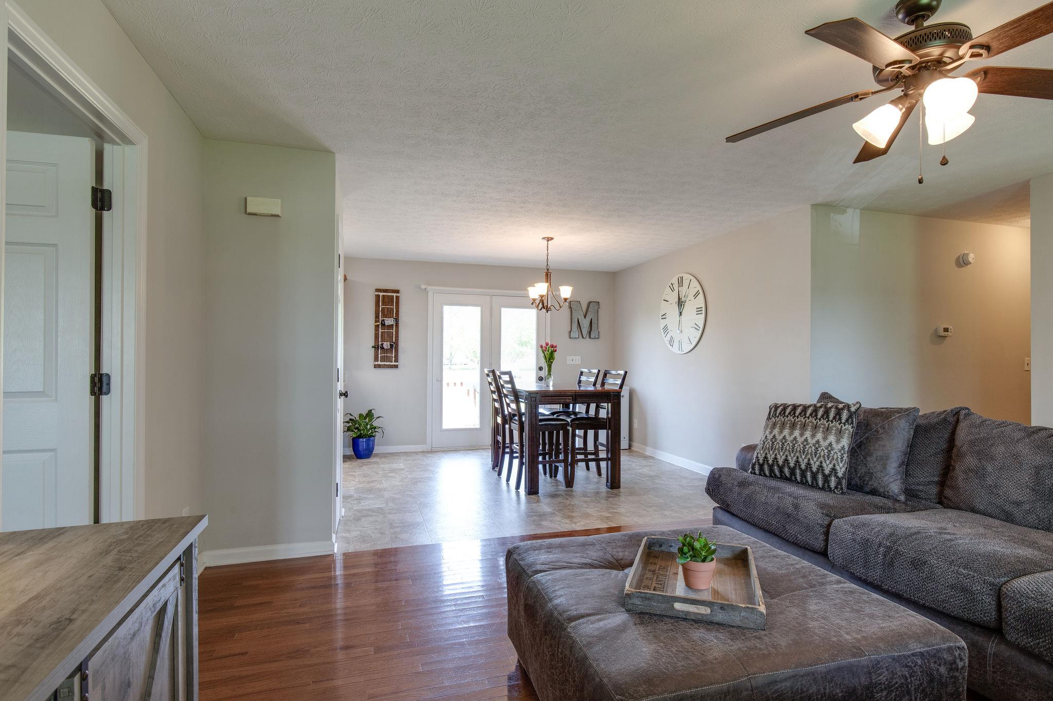 349 Lear Road Portland, TN 37148 - Photo 6 of 24 a living room with furniture and a dining table with wooden floor