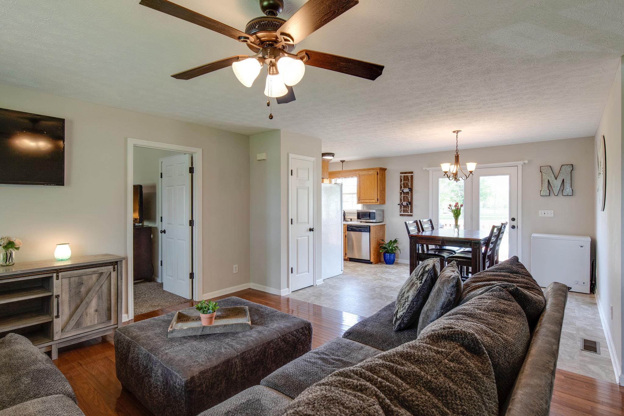 349 Lear Road Portland, TN 37148 - Photo 7 of 24 a living room with furniture a chandelier and a flat screen tv