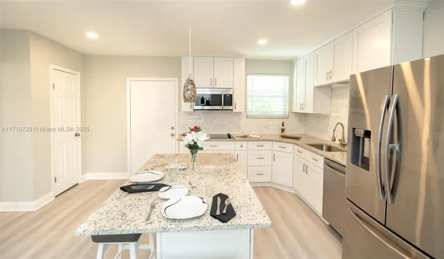 a bathroom with a sink vanity and mirror