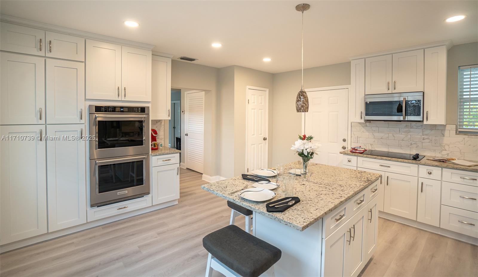 2230 Southwest 60th Court Miami, FL 33155 - Photo 28 of 64 a kitchen with a stove a sink and a refrigerator