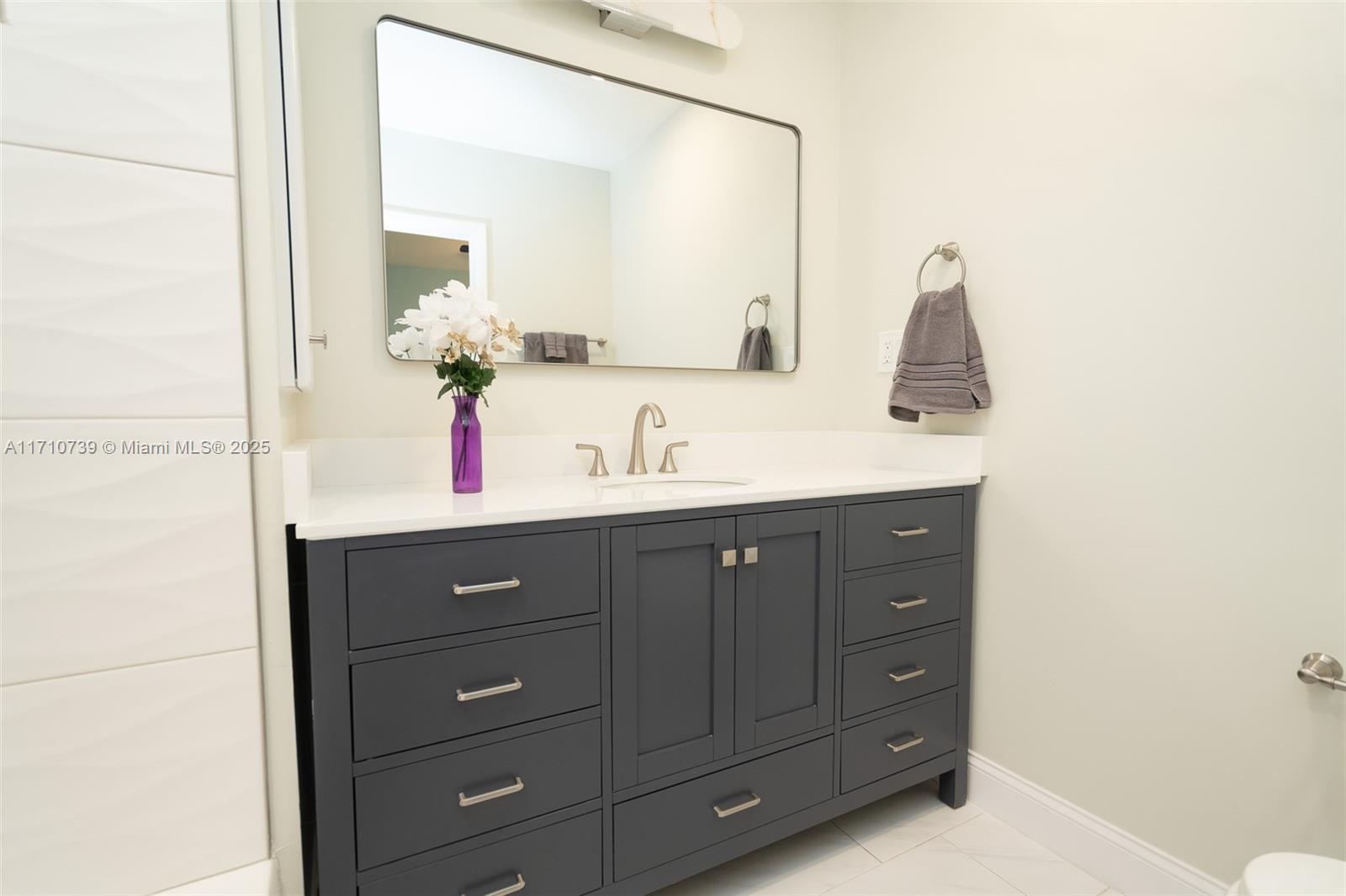 2230 Southwest 60th Court Miami, FL 33155 - Photo 33 of 64 a bathroom with a sink vanity and mirror