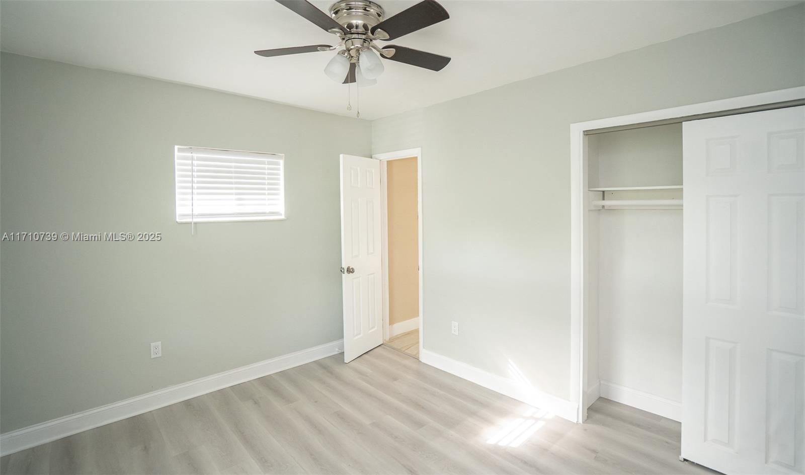 2230 Southwest 60th Court Miami, FL 33155 - Photo 42 of 64 a view of an empty room with wooden floor and a window