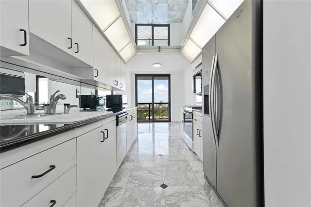 a bathroom with a sink a toilet a mirror and a shower