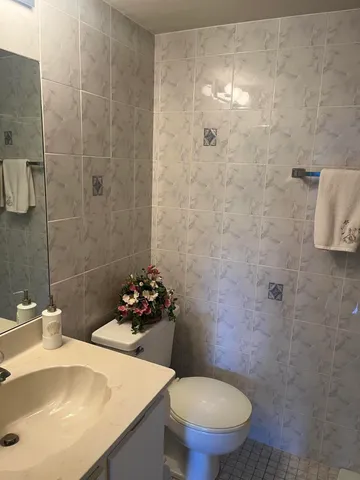 a bathroom with a sink toilet and a mirror