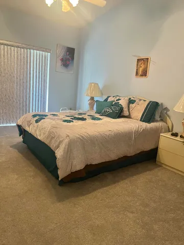 a bedroom with a bed and a couch