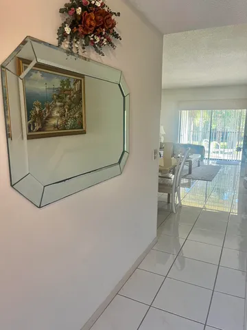 a living room with couches and a painting on the wall