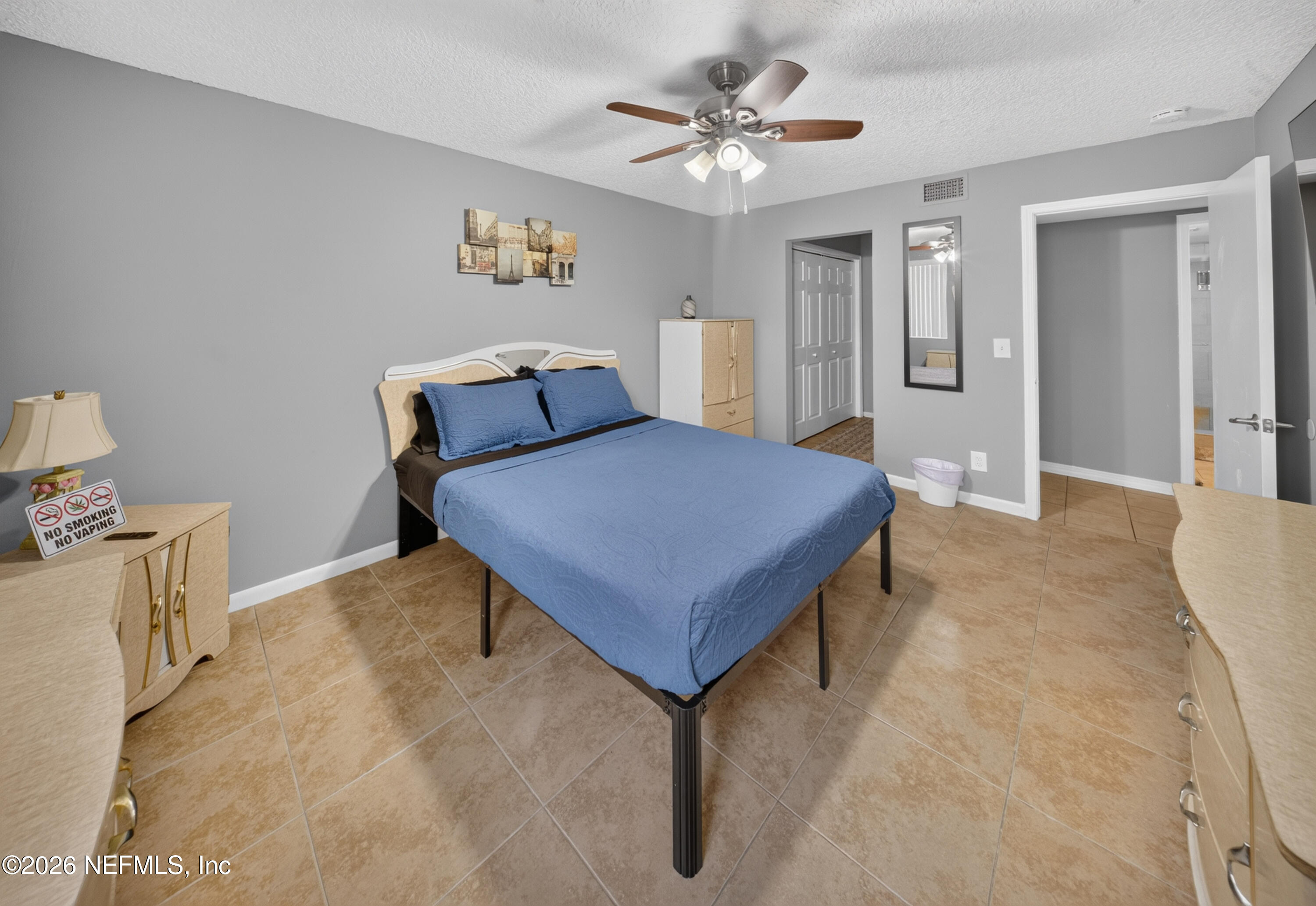 7346 El Barco Road, Unit 4 Jacksonville, FL 32216 - Photo 8 of 19 a bedroom with a bed and a chandelier