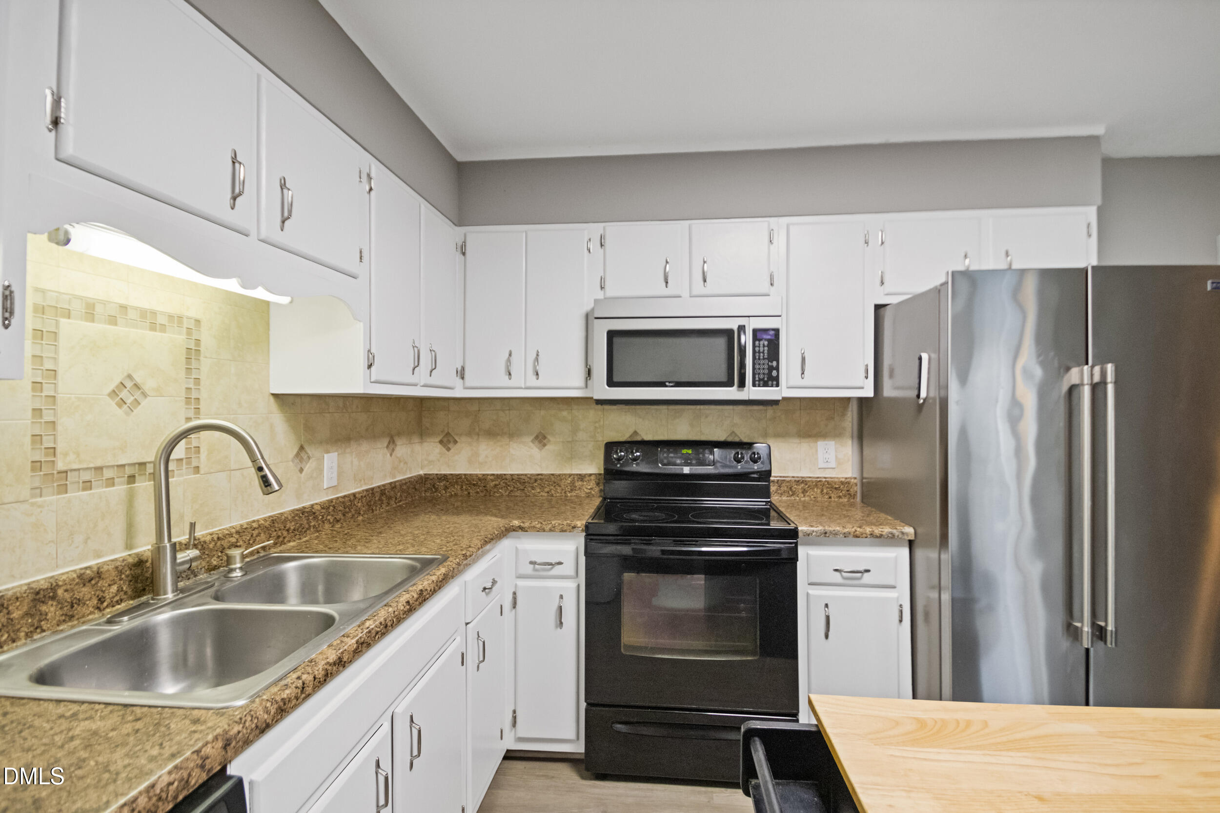 5909 Spinner Road Hope Mills, NC 28348 - Photo 13 of 24 a kitchen with granite countertop a sink stove and refrigerator