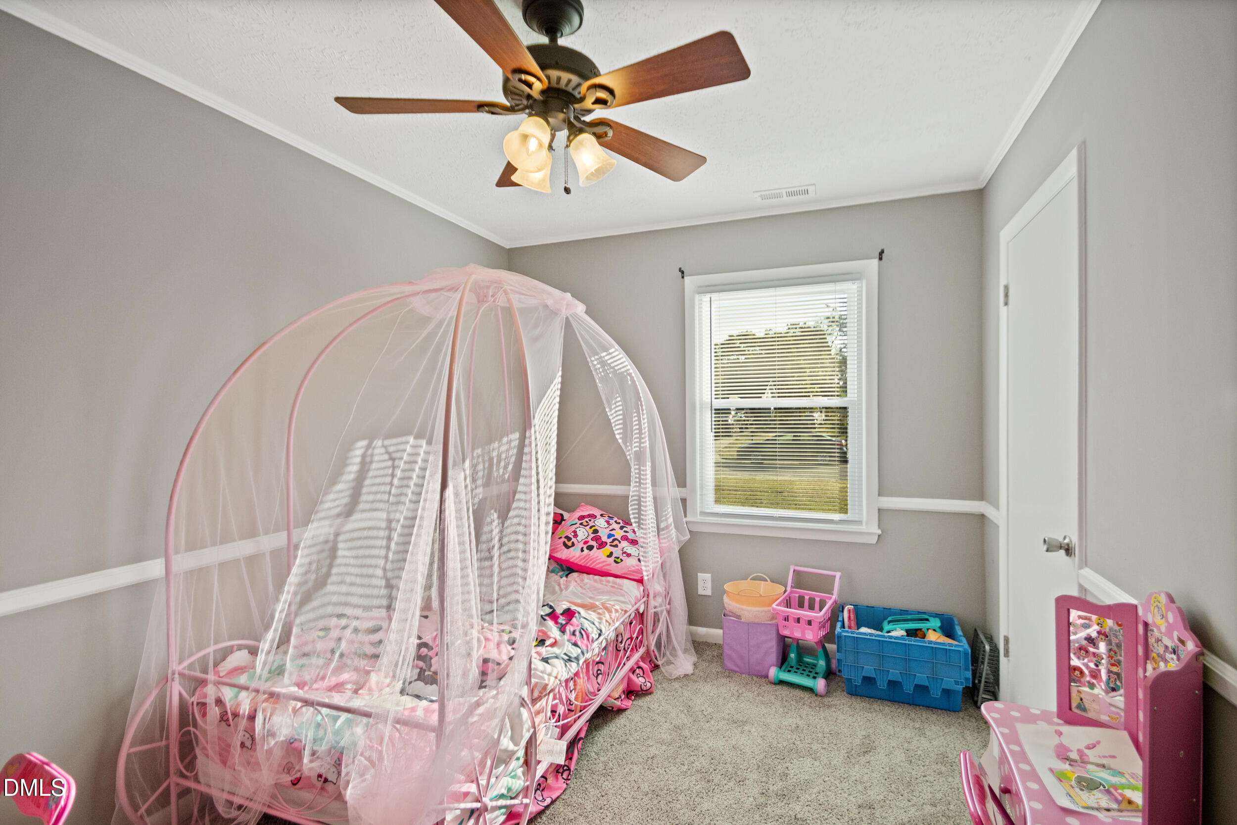 5909 Spinner Road Hope Mills, NC 28348 - Photo 15 of 24 a bedroom with a bed and a chandelier