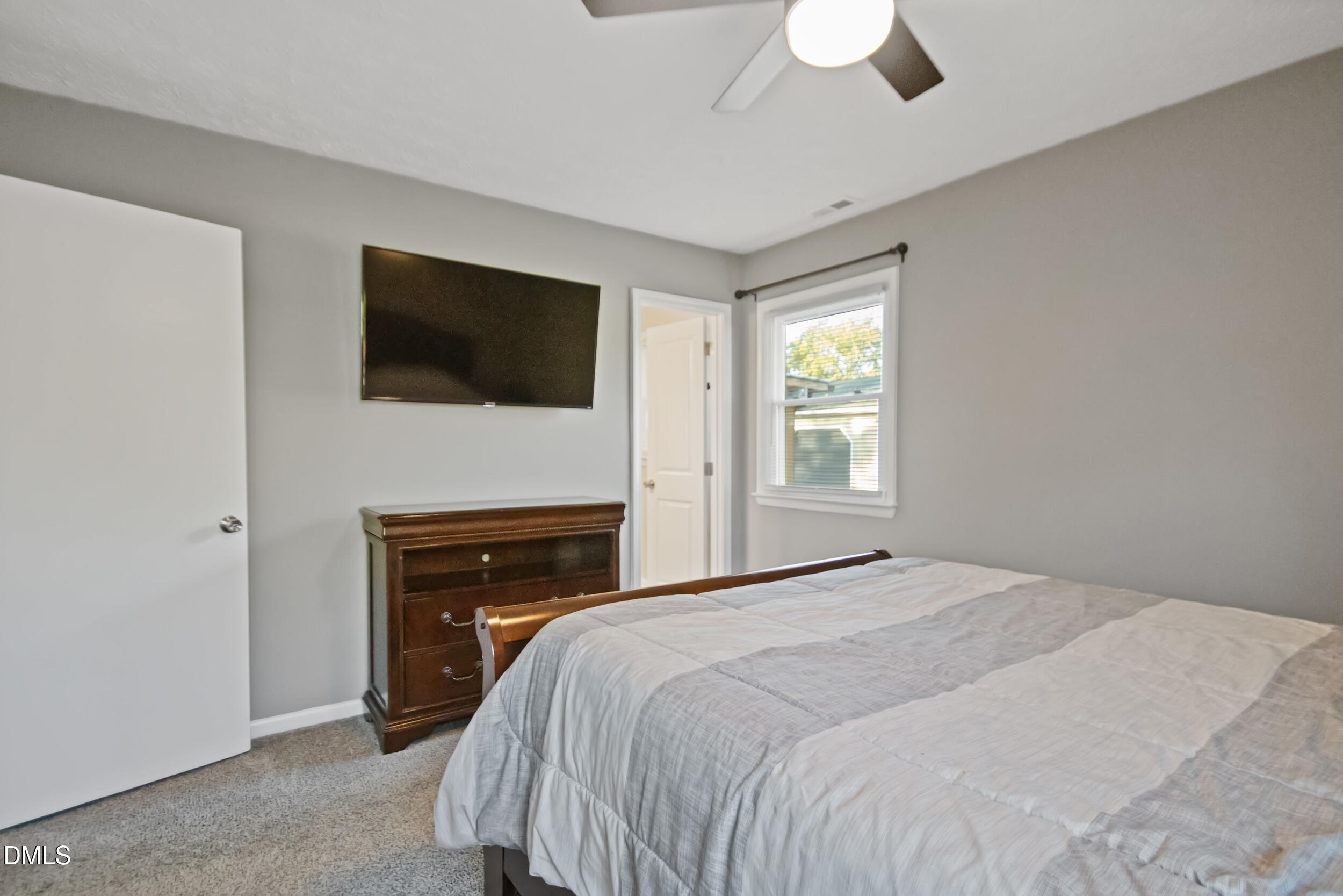 5909 Spinner Road Hope Mills, NC 28348 - Photo 18 of 24 a bedroom with a bed and a flat screen tv