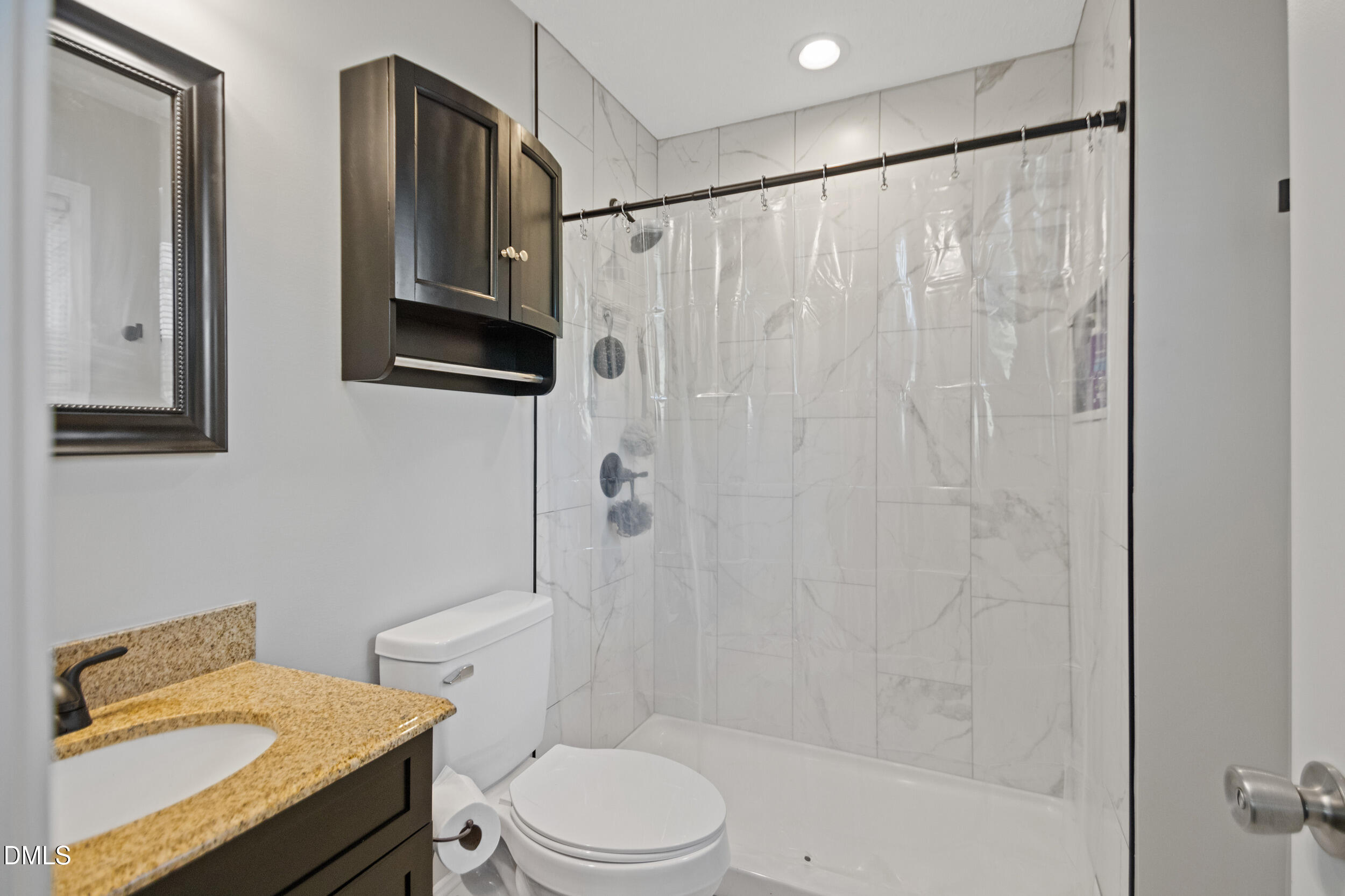 5909 Spinner Road Hope Mills, NC 28348 - Photo 19 of 24 a bathroom with a granite countertop sink toilet and shower