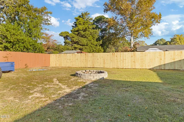 a house view with swimming pool and wooden fence