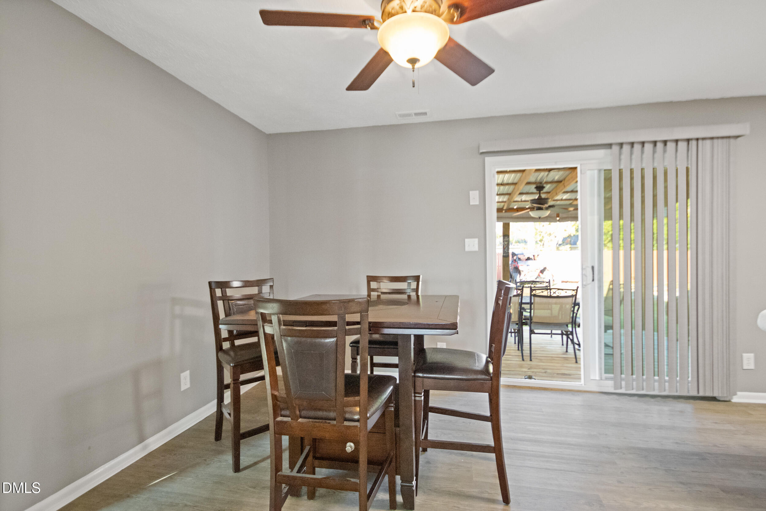 5909 Spinner Road Hope Mills, NC 28348 - Photo 7 of 24 a view of a dining room with furniture and wooden floor