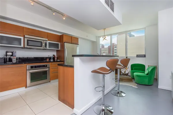 a kitchen with stainless steel appliances granite countertop a sink and cabinets