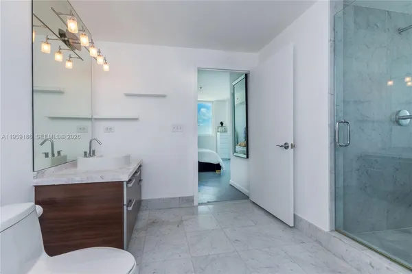 a bathroom with a toilet sink and shower