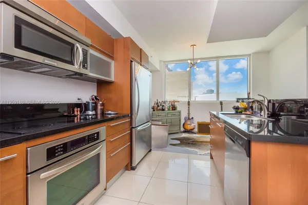 a kitchen with stainless steel appliances granite countertop a sink and cabinets