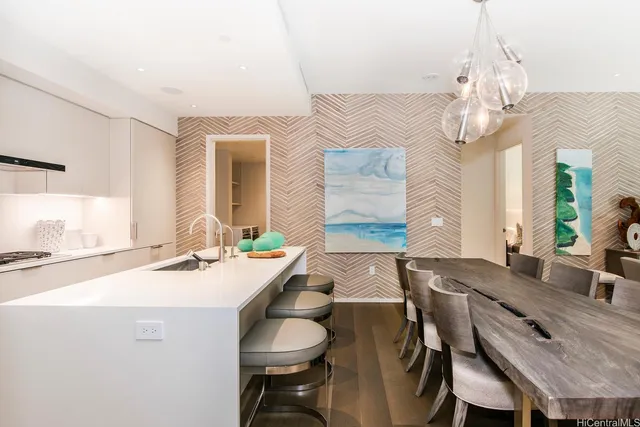 a dining room with wooden floor a chandelier a wooden table and chairs