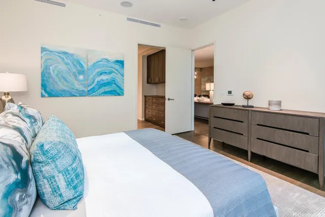 a bedroom with a bed and a dresser