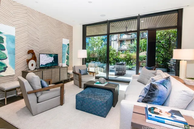 a living room with furniture large windows and a flat screen tv