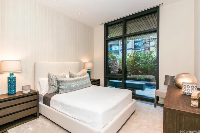 a bedroom with a bed and a lamp next to a window