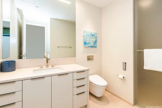 a bathroom with a granite countertop sink a toilet and a mirror