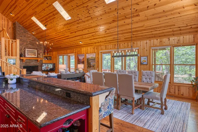 a view of a dining room with furniture a chandelier and wooden floor