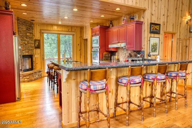 a kitchen with stainless steel appliances granite countertop a stove a sink and a refrigerator
