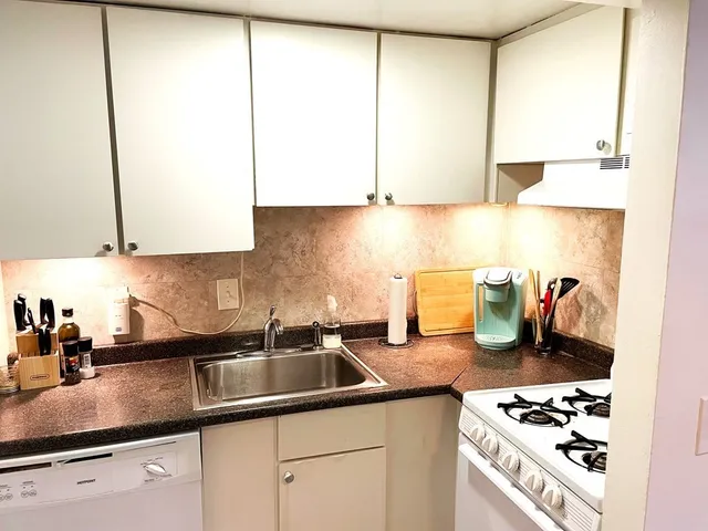 a kitchen with sink and cabinets