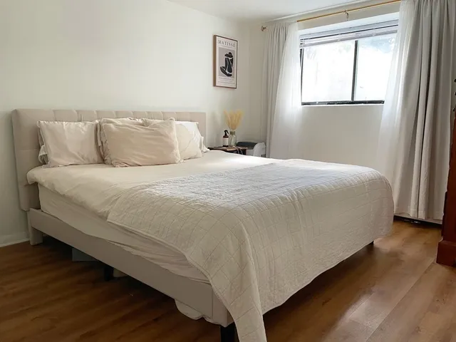 a bedroom with a bed and a window