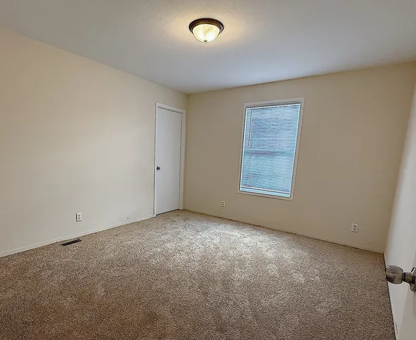 an empty room with a view of a livingroom