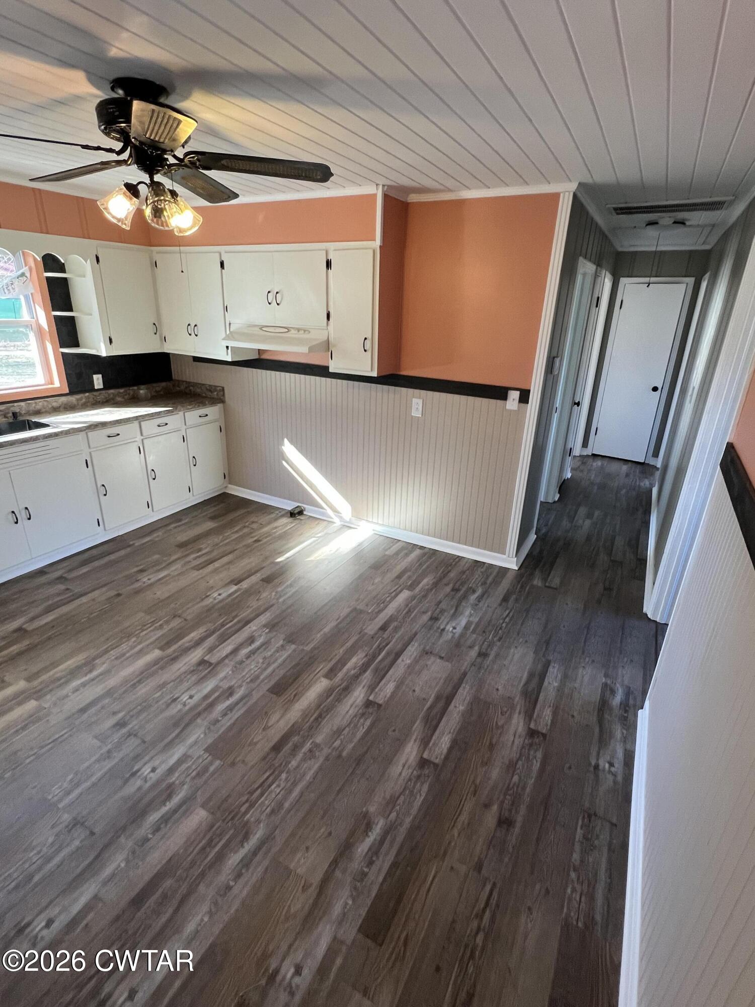 2094 Old Stage Road Adamsville, TN 38310 - Photo 7 of 12 a view of a kitchen with a sink and wooden floor