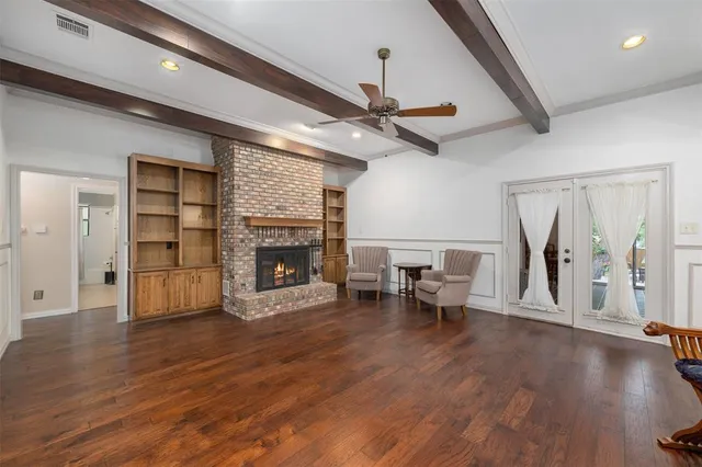 a bathroom with a granite countertop double vanity sink a mirror and a toilet