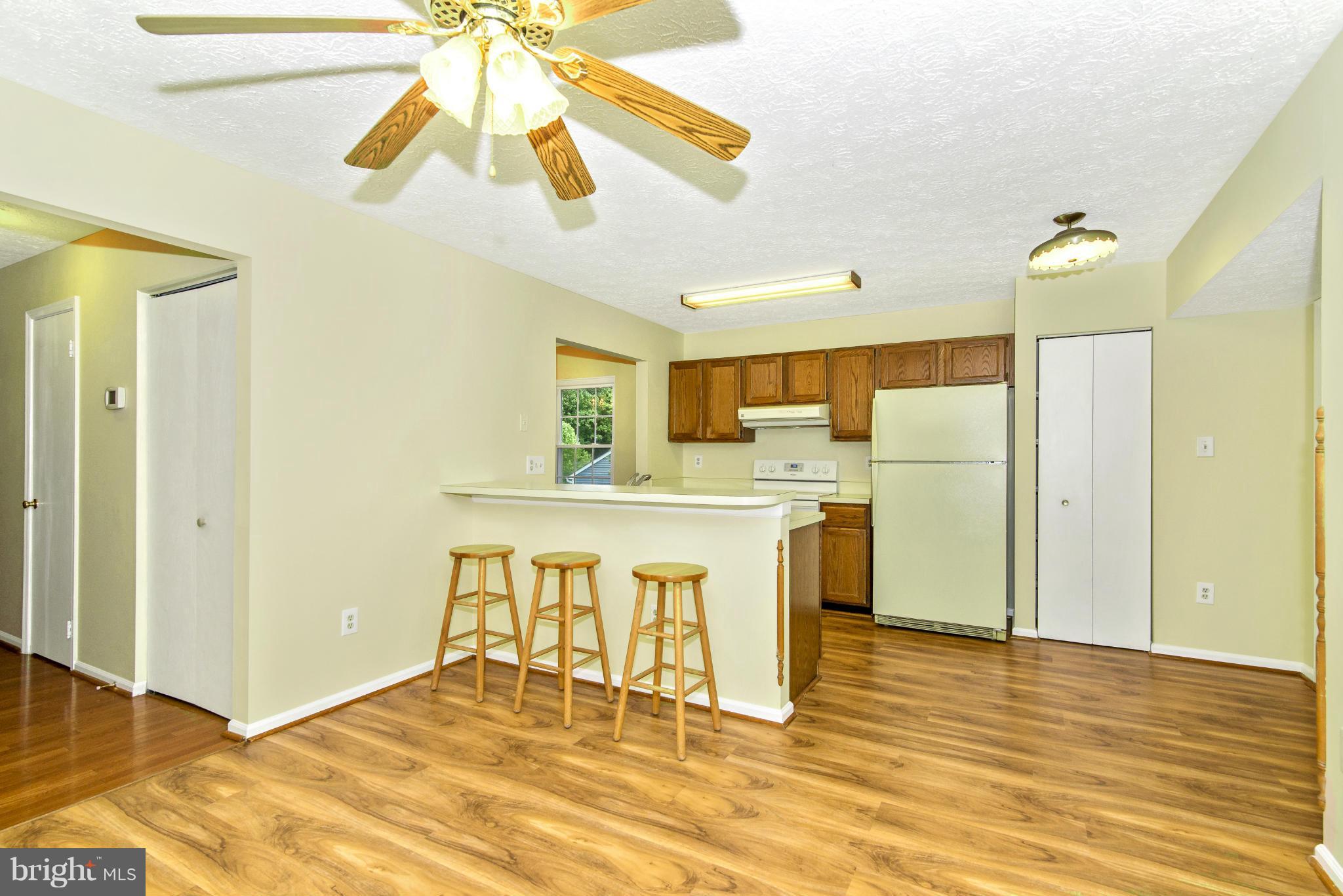 1709 Brookshire Run Point of Rocks, MD 21777 - Photo 14 of 24 a kitchen with stainless steel appliances granite countertop a sink cabinets and wooden floor