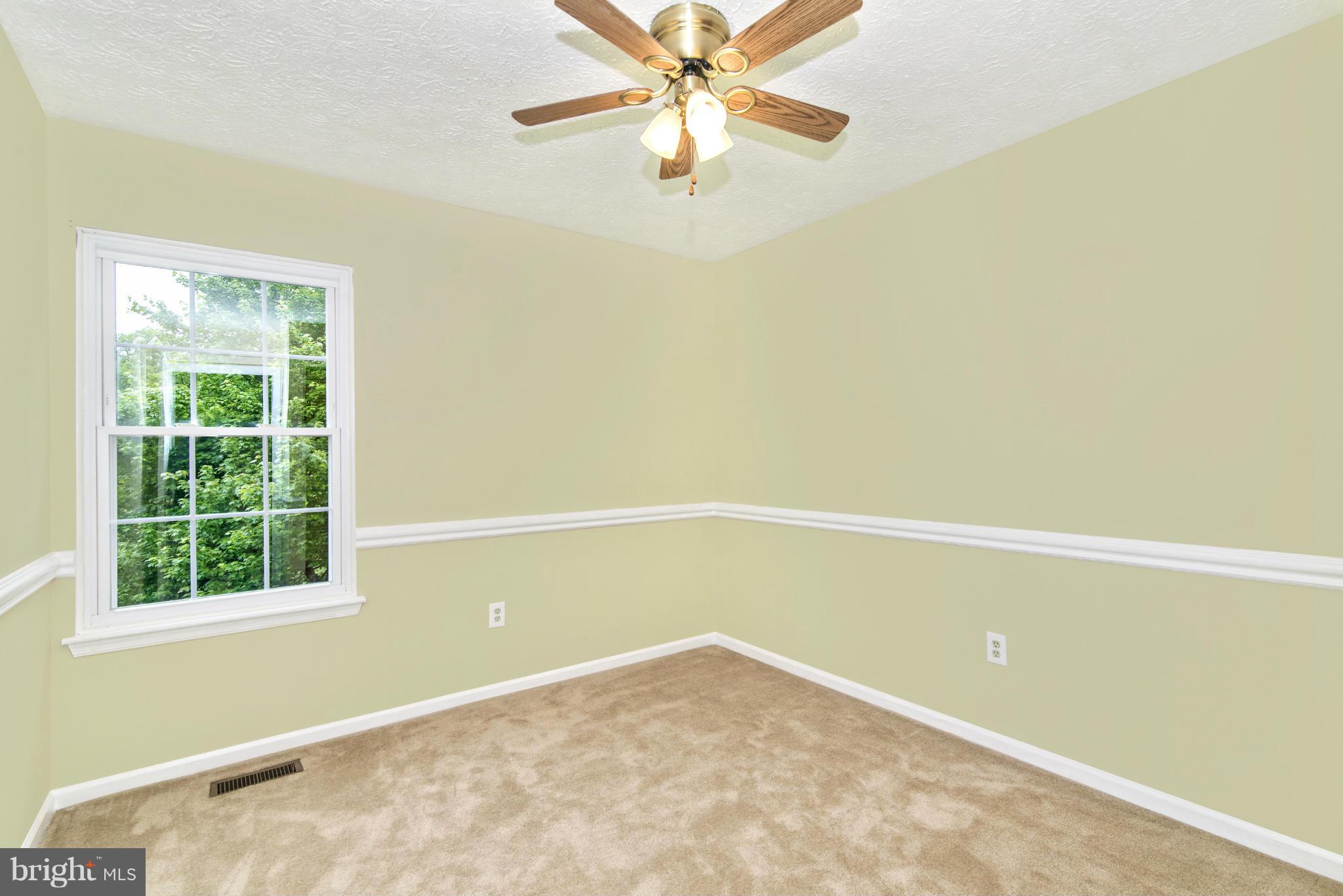 1709 Brookshire Run Point of Rocks, MD 21777 - Photo 22 of 24 an empty room with a window and a ceiling fan