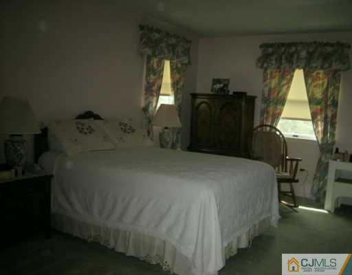 9 King Road Somerset, NJ 08873 - Photo 6 of 8 a bedroom with a bed and wooden floor