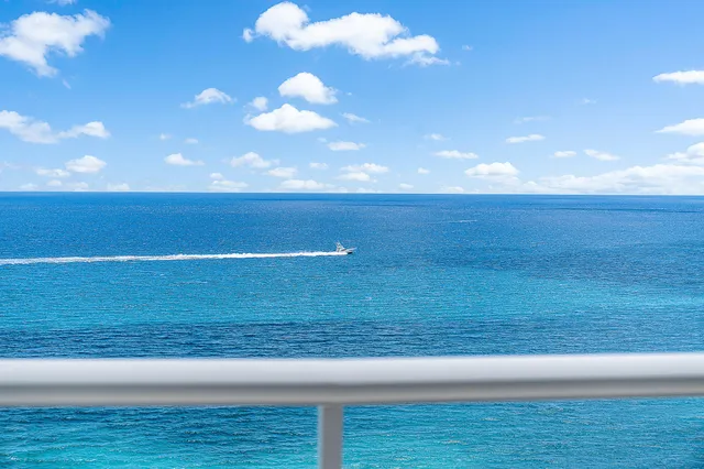 a large kitchen with kitchen island granite countertop a large counter top space a sink stainless steel appliances and cabinets