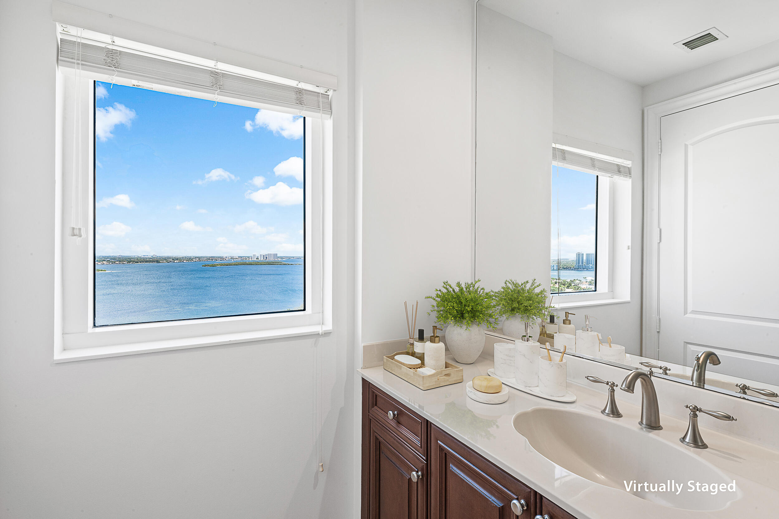 4600 North Ocean Drive, Unit 1903 Singer Island, FL 33404 - Photo 19 of 49 a bathroom with a granite countertop sink and a mirror