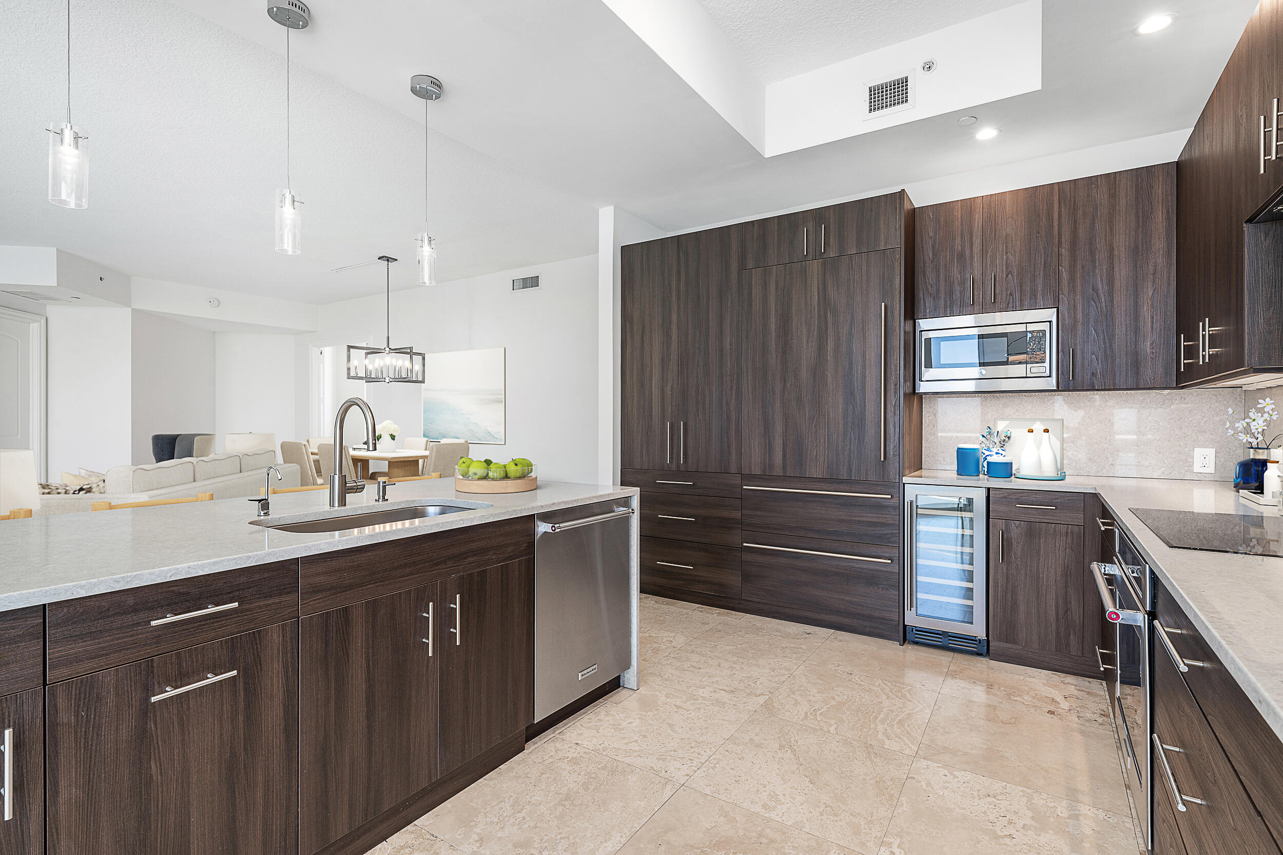 4600 North Ocean Drive, Unit 1903 Singer Island, FL 33404 - Photo 5 of 49 a kitchen with a sink and wooden cabinets