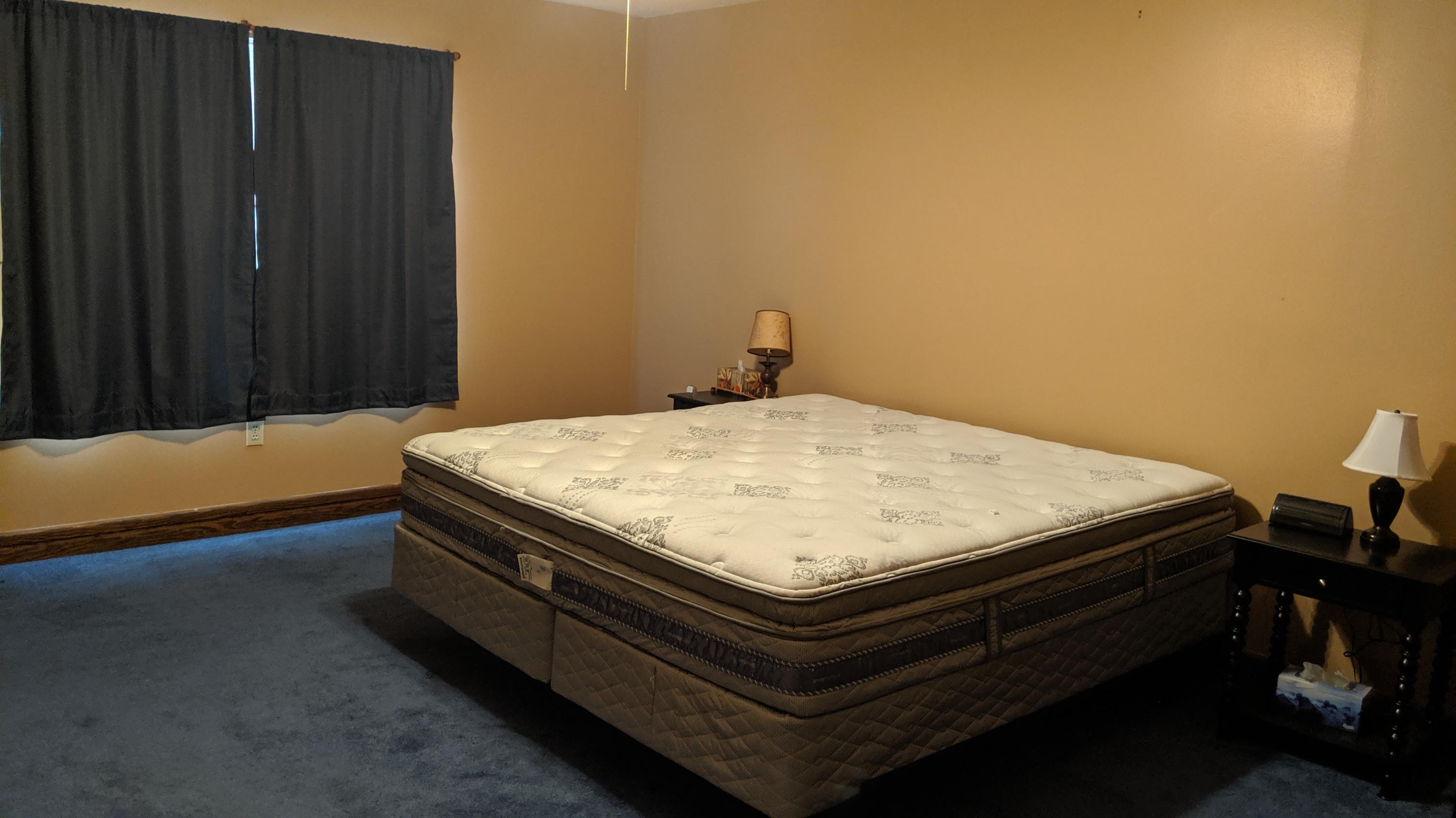 602 Valley Road Crestview, FL 32539 - Photo 18 of 34 a bed sitting in a bedroom next to a wooden door
